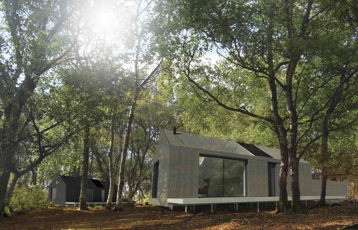 'Microhouse' of very simple container-style design, light brown coloured with large windows, with a shed in the rear and surrounded by tall trees in daylight.