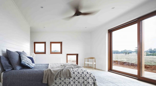 The master bedroom has three small, south-facing windows and double-glazed doors to the west which provide sunset views, but are protected by awnings to exclude direct summer sun.