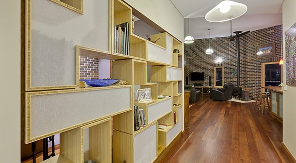 Between the hallway and the study, a custom-designed bamboo ply shelving unit provides storage and balances privacy and connection.