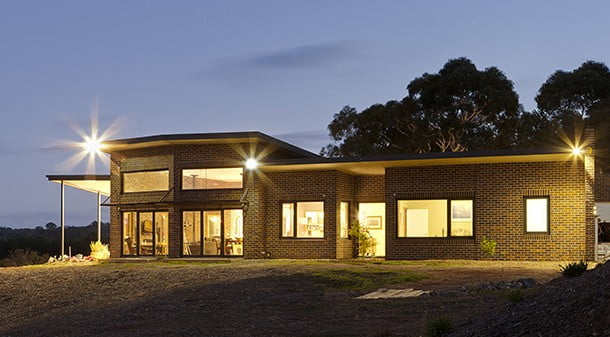 Due to the bushfire risk of the site, brick, Colorbond and fire-resistant glass were chosen for the home's exterior. Ann and Ali saved some money by using seconds bricks.