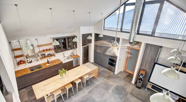 By choosing a standalone addition, Paul was able to leave the original roofline intact, saving time and cost and providing a clear distinction between the new and old. The high vaulted ceiling gives a sense of space, as does the kitchen island cum dining table. 