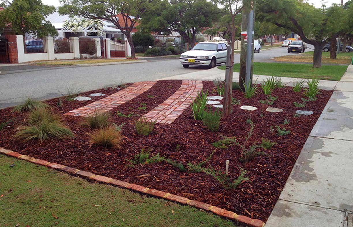 This multi-purpose verge, once fully grown, will eventually hide the parking space. Tip: Make sure you lower the soil level for verge gardens so mulch is contained behind the kerb.  